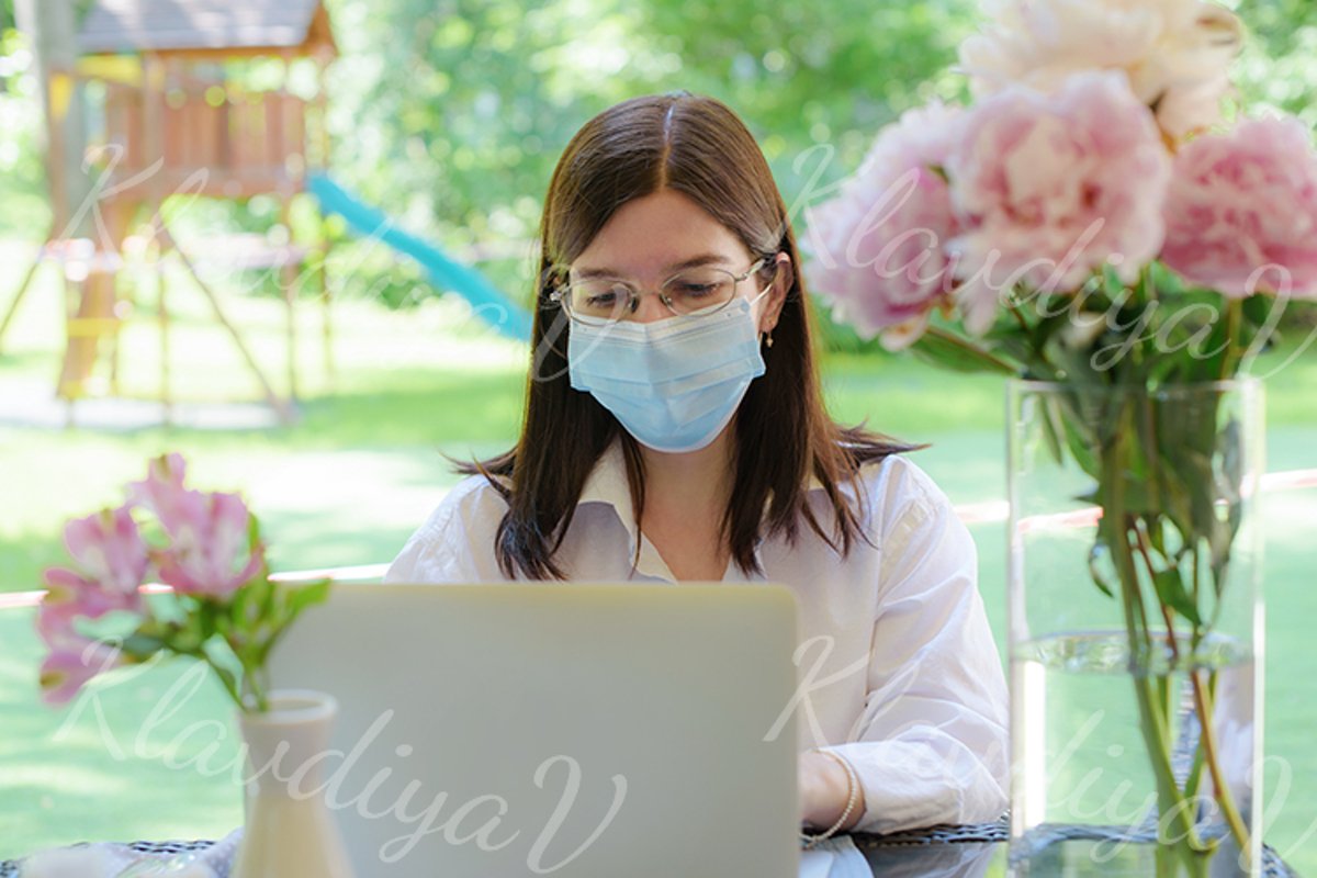 works at a laptop on the summer veranda example image 1