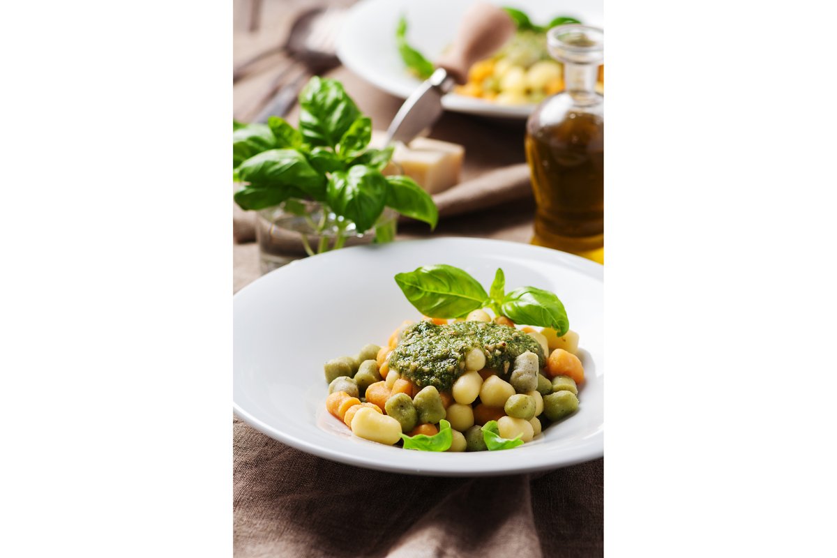 Colored gnocchi with pesto, selective focus example image 1