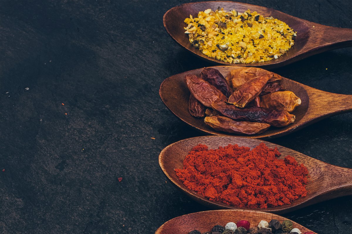Colorful various spices in wooden spoons on old dark example image 1
