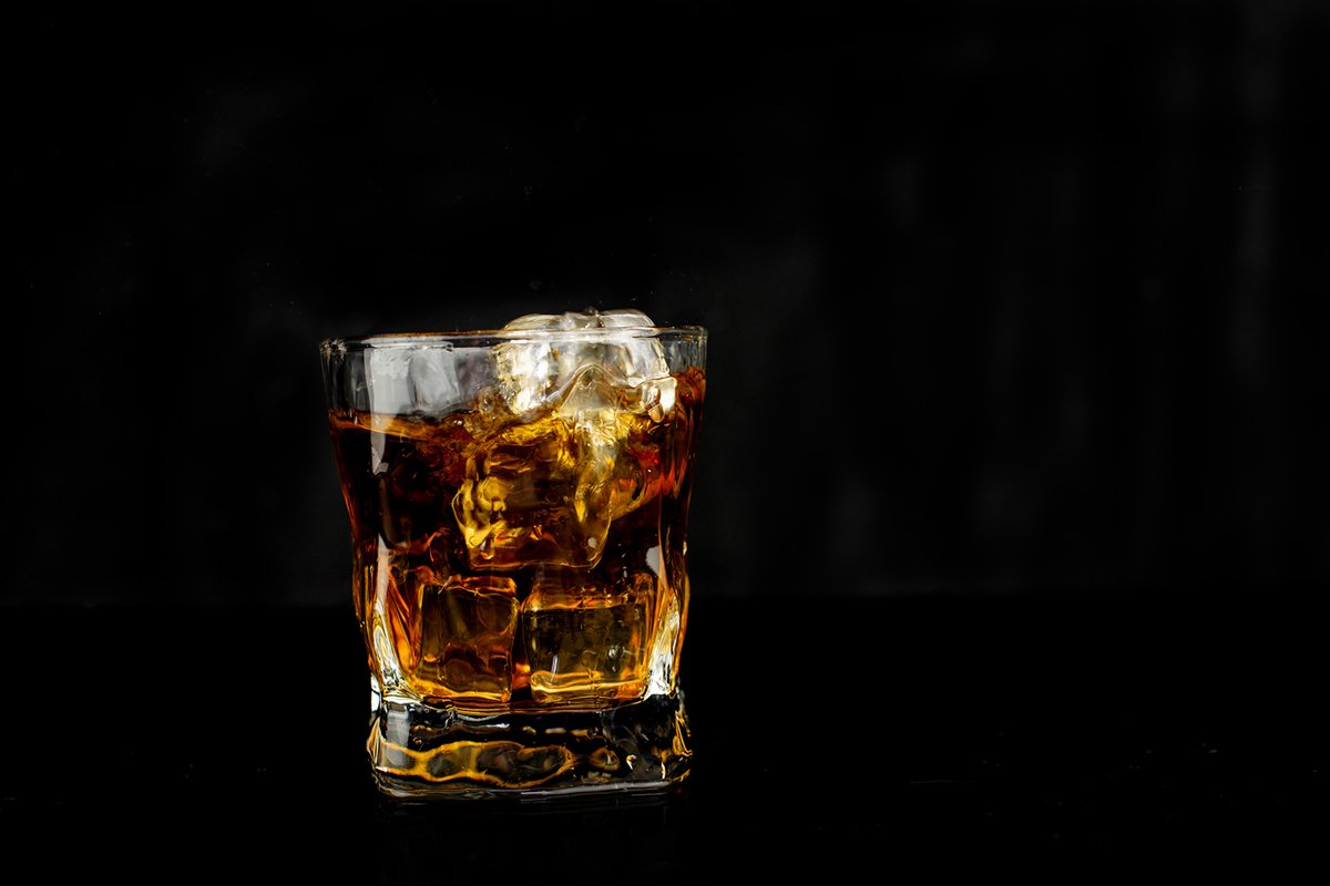 alcohol drink whiskey with ice cubes on a black background example image 1