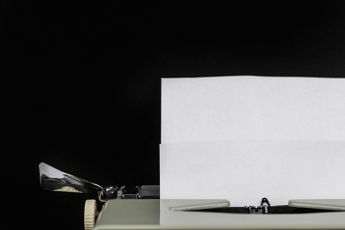 Typewriter on the table on a black background example image 1