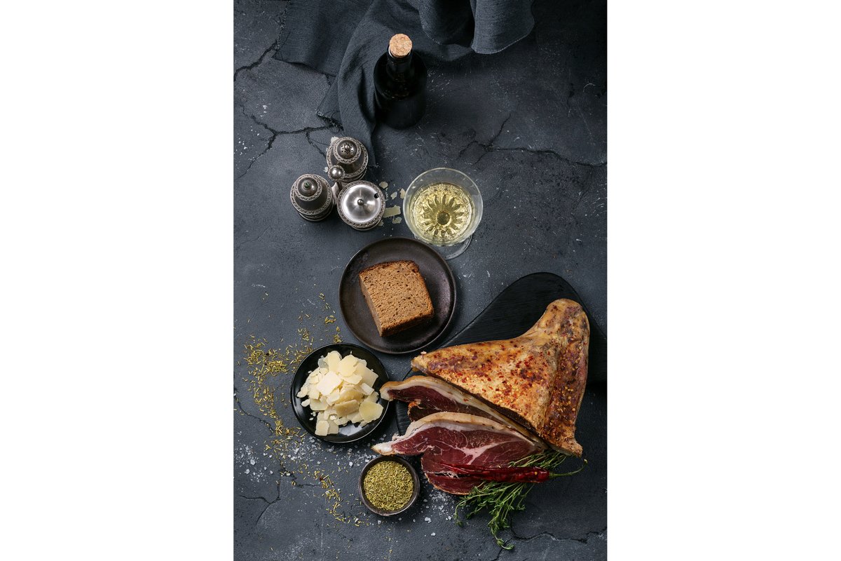 Prosciutto Ham served on a rustic wooden board example image 1