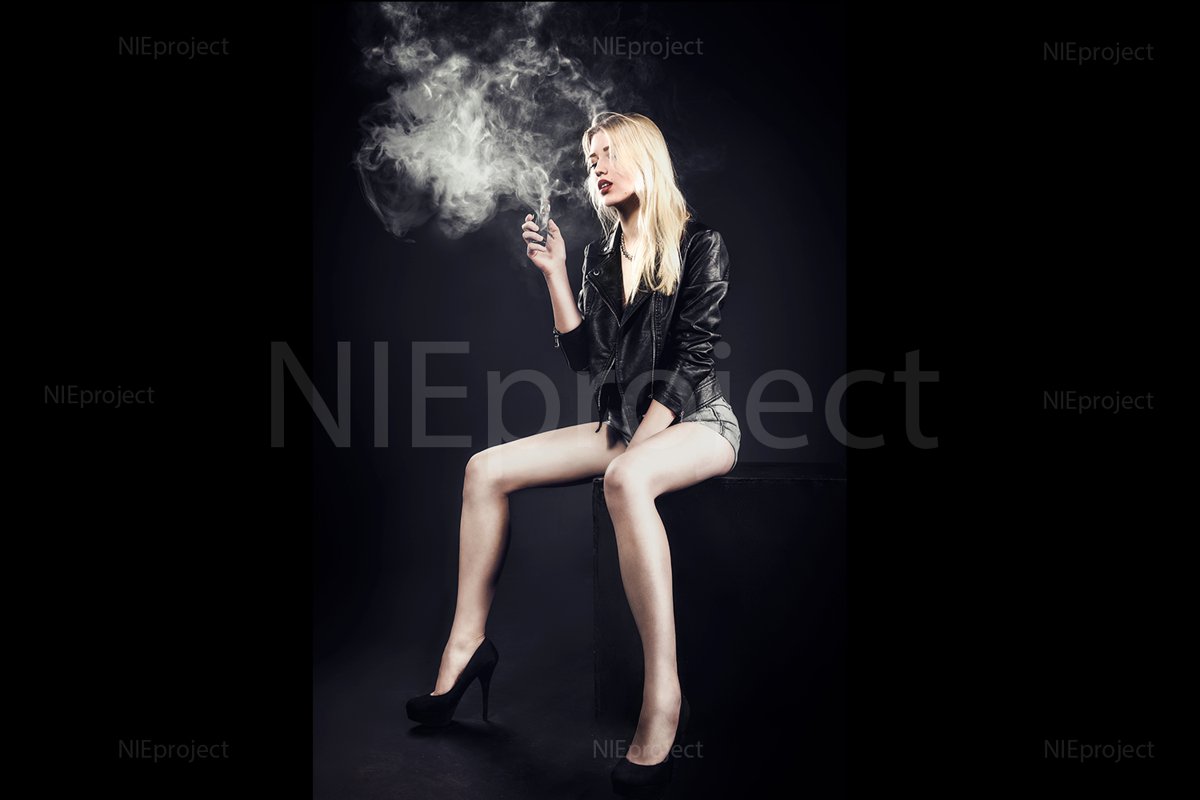 relaxed cute girl model smokes vape in studio example image 1