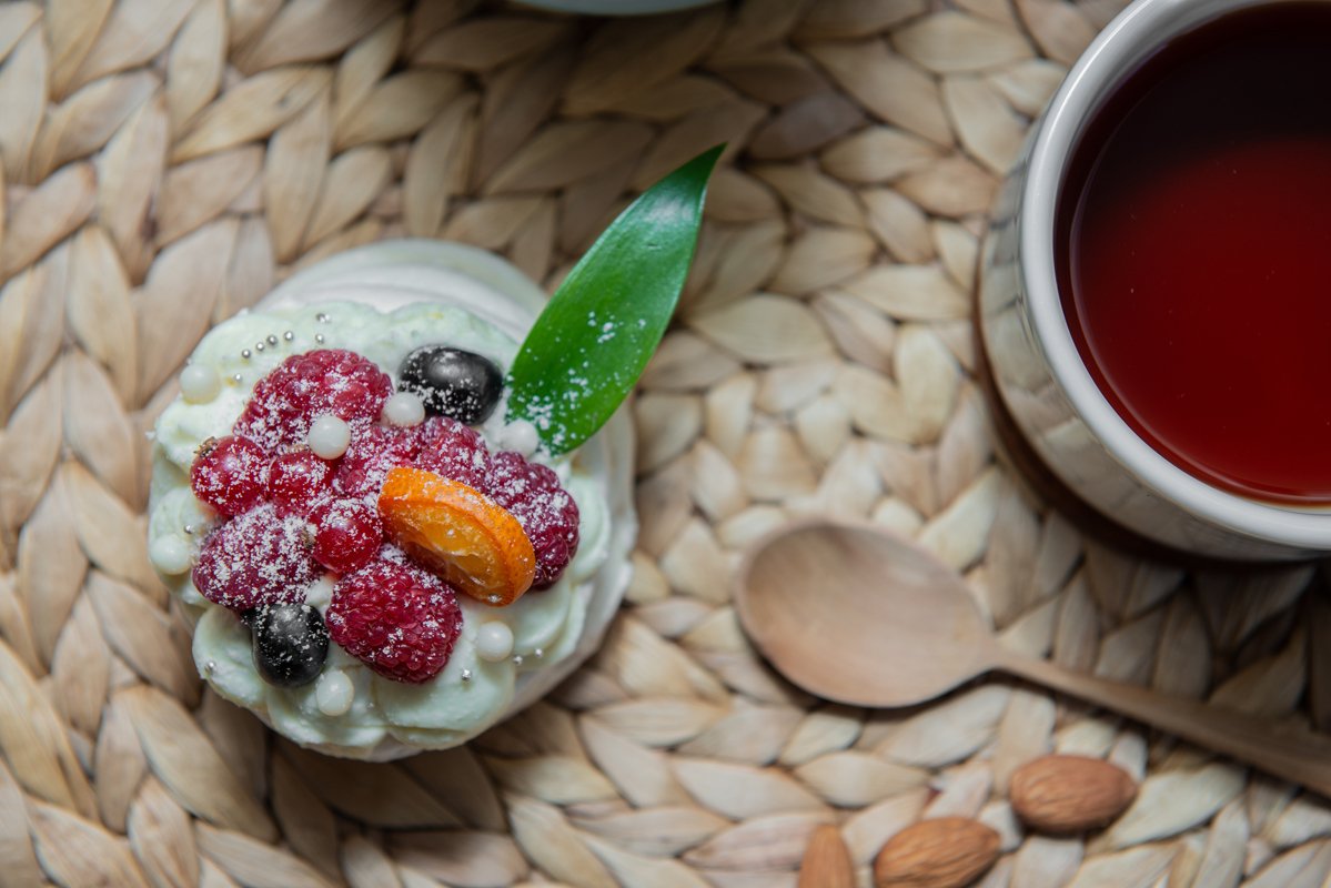 Pavlova meringue desert cake with cream and small fruits example image 1