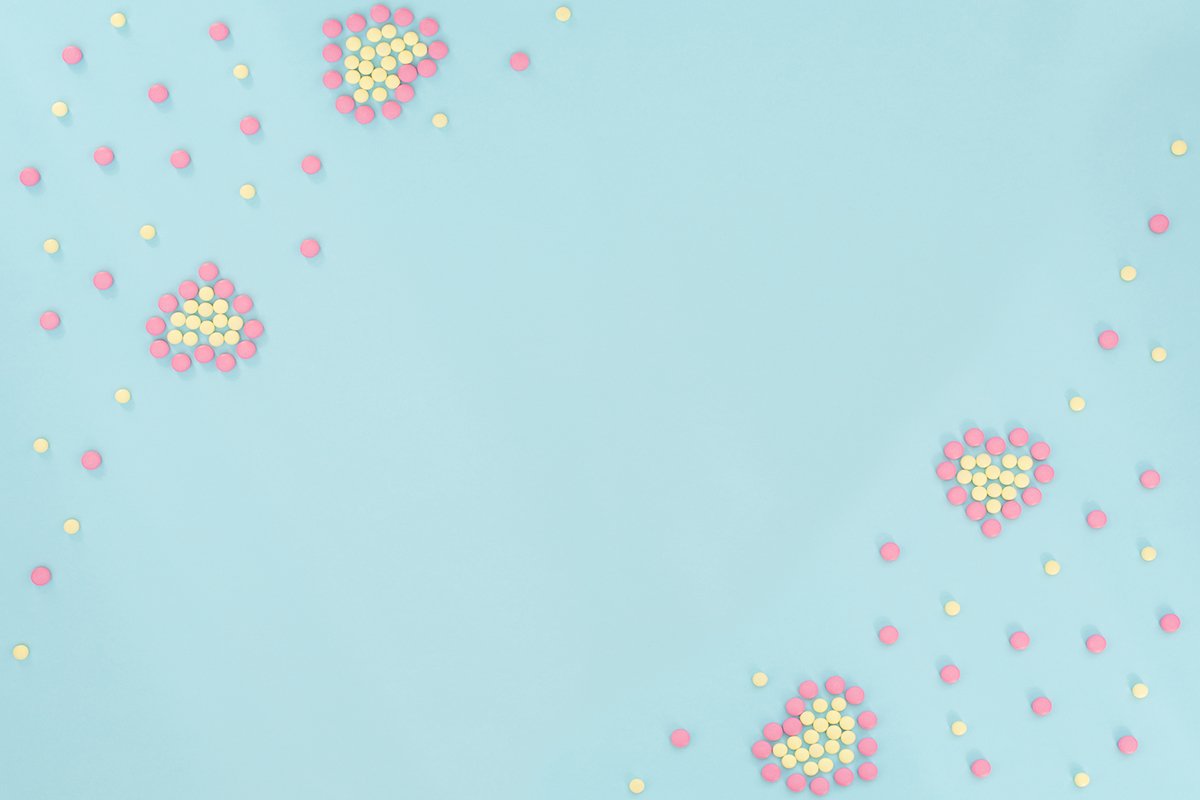 Two hearts made of pink and yellow pills example image 1