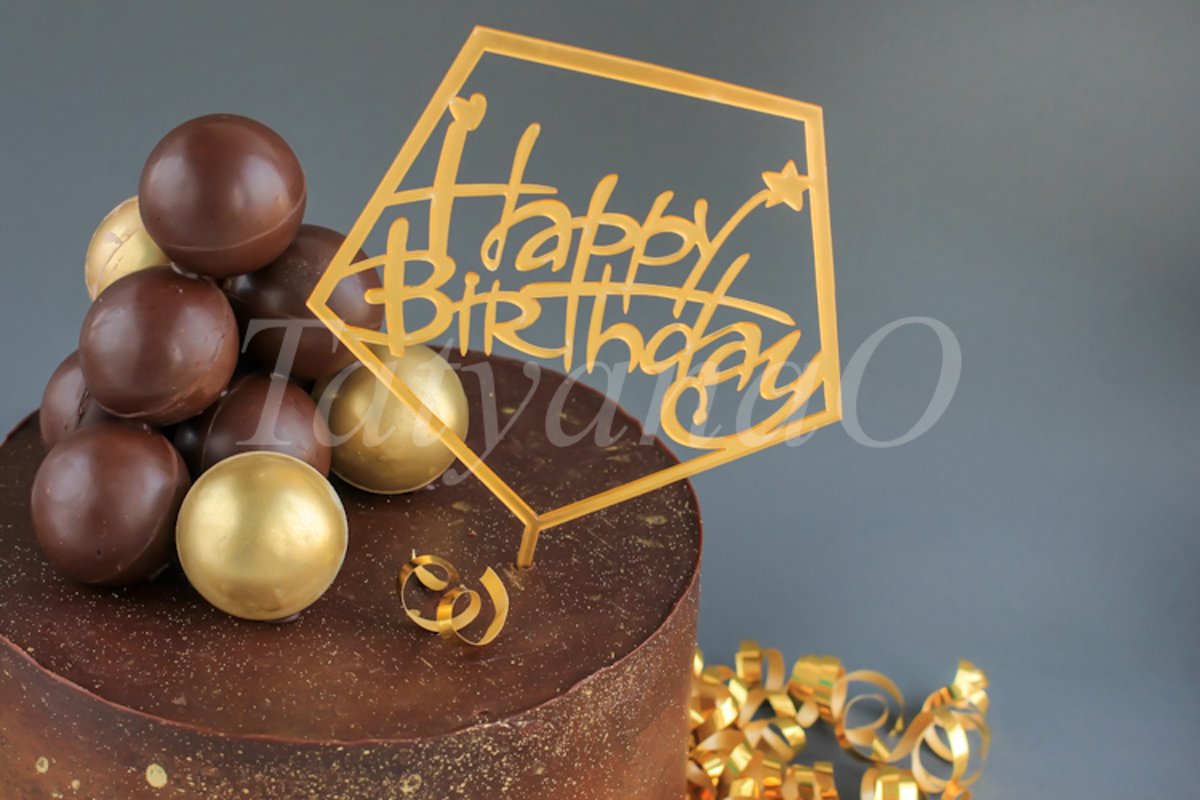 Chocolate birthday cake with gold decorations. example image 1