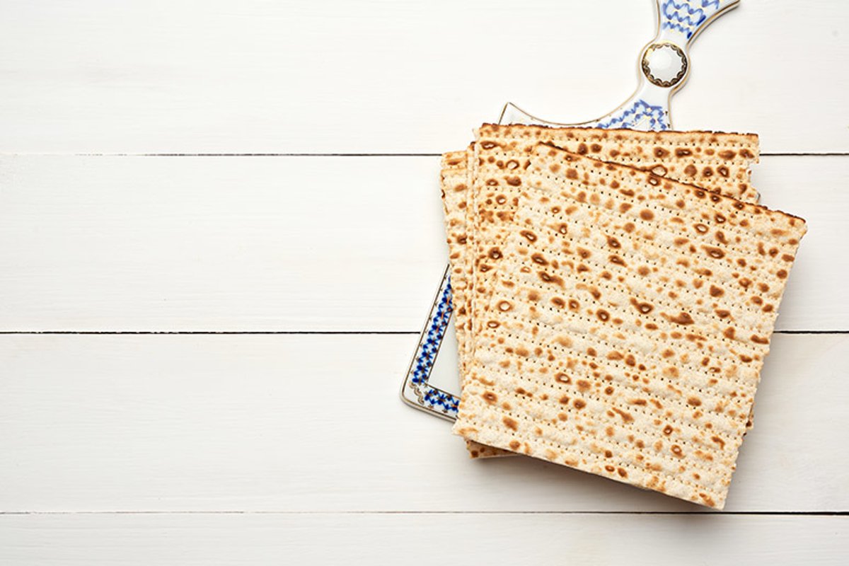 stack of baked square matzo on a white wooden background example image 1