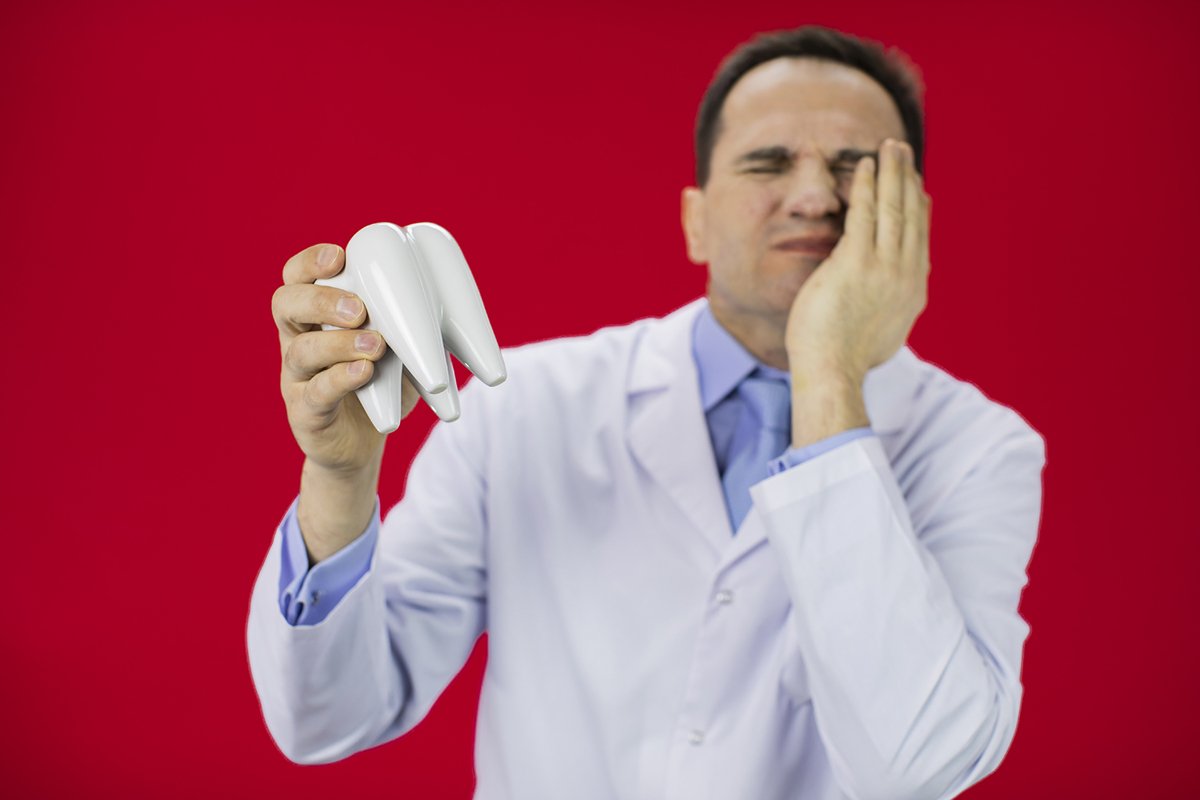 Doctor therapist with a stethoscope on a red background example image 1
