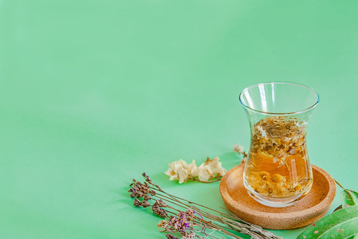 Cup of herbal tea with chamomile flowers. example image 1