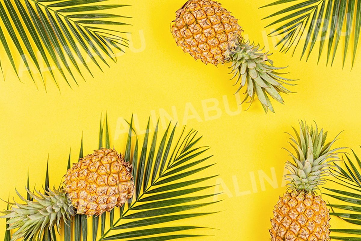 Pineapples and tropical palm leaves on yellow background example image 1