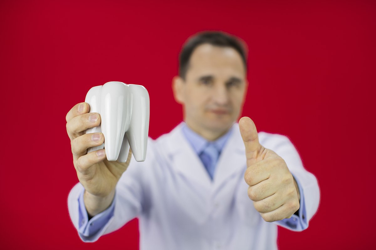 Doctor therapist with a stethoscope on a red background example image 1