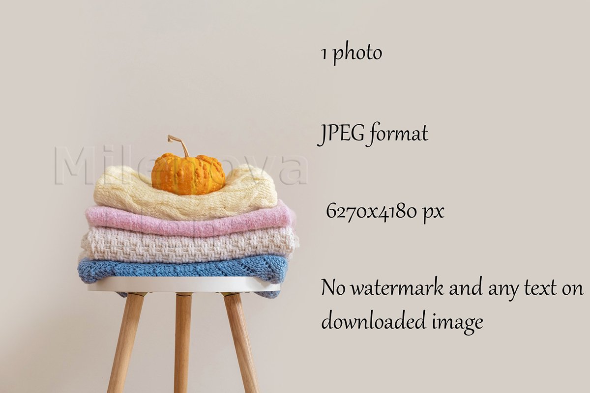 Pile of handmade knitted sweaters blankets folded on chair example image 1