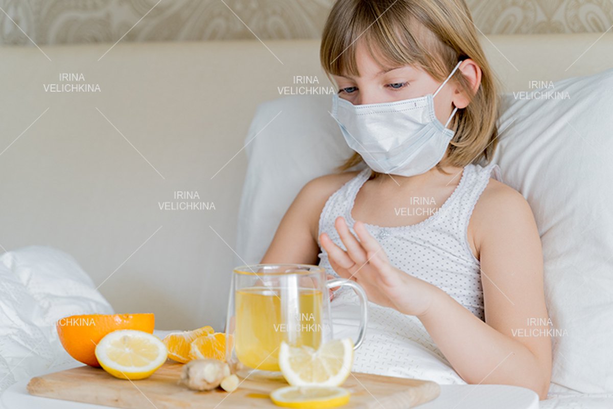 Sick girl in bed. Face mask.Cup of tea, orange,lemon,ginger example image 1