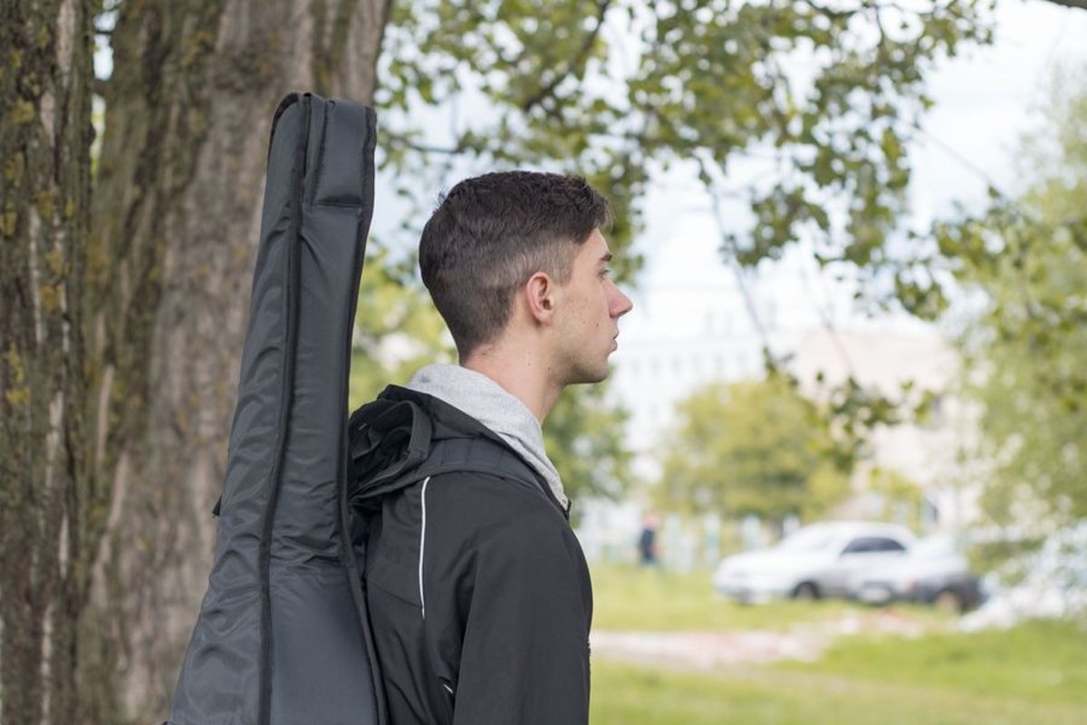 Young caucasian man with guitar in the park example image 1