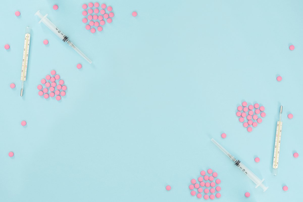 Two hearts made of pink pills, thermometer, syringe example image 1