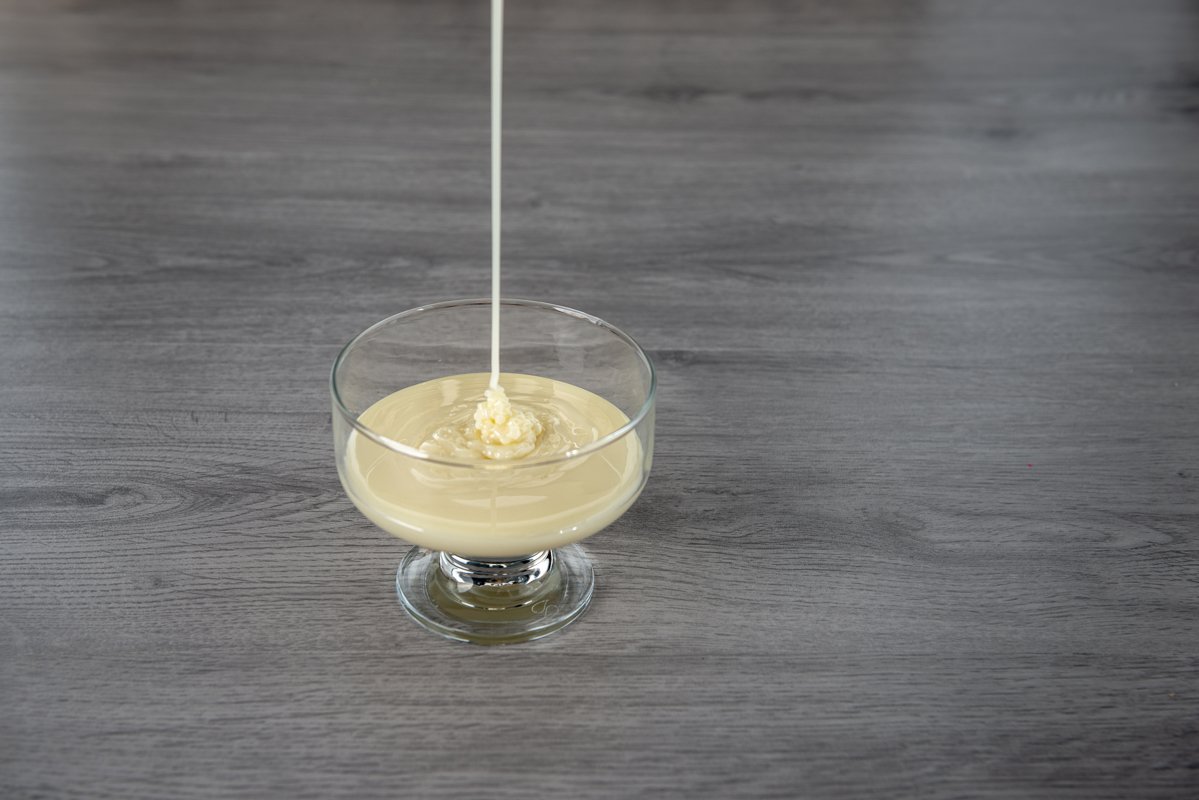 condensed milk in a transparent glass bowl example image 1