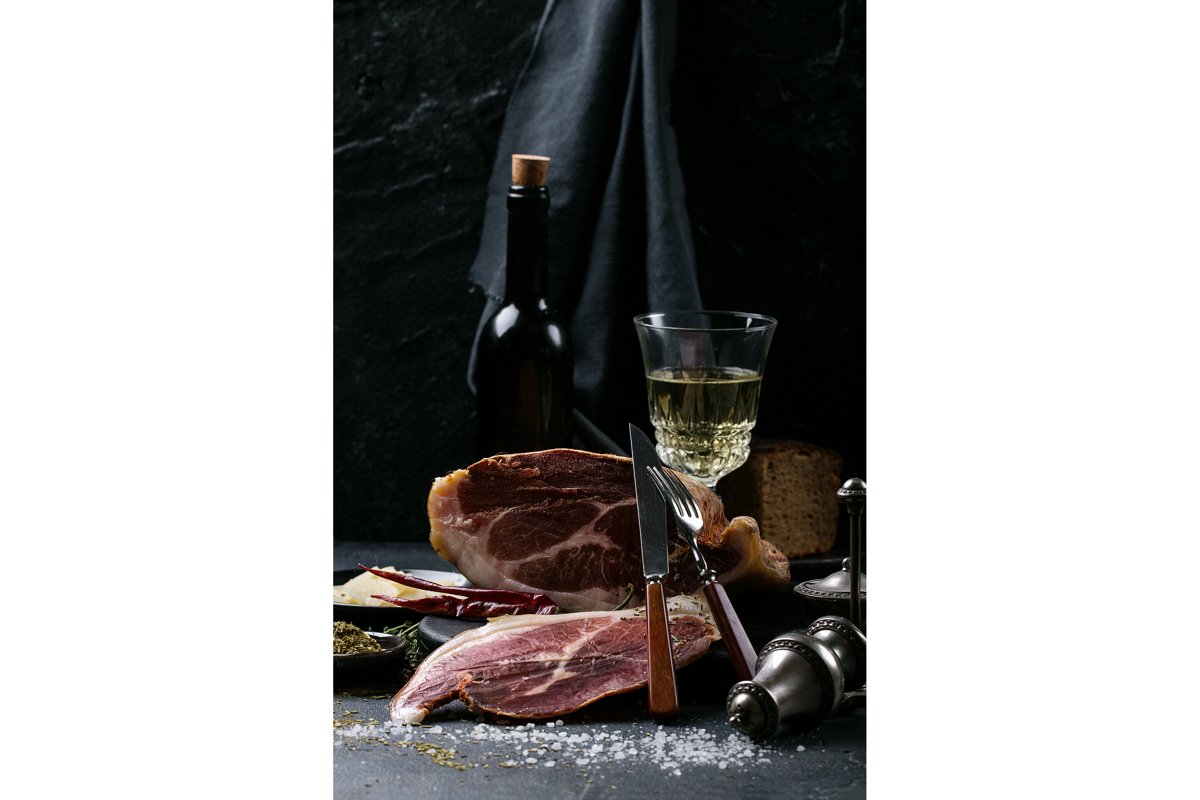 Prosciutto Ham served on a rustic wooden board example image 1
