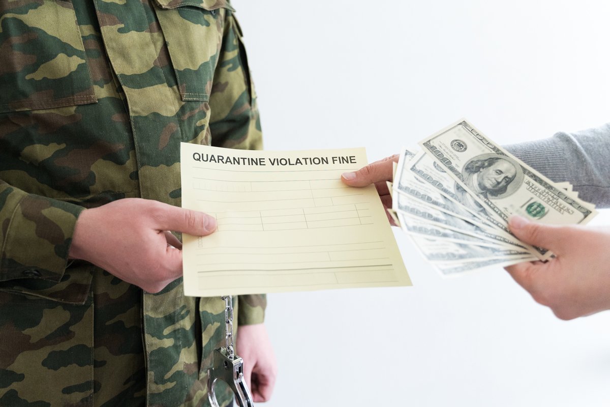 Police officer with self-isolation violation fine. Pay money example image 1
