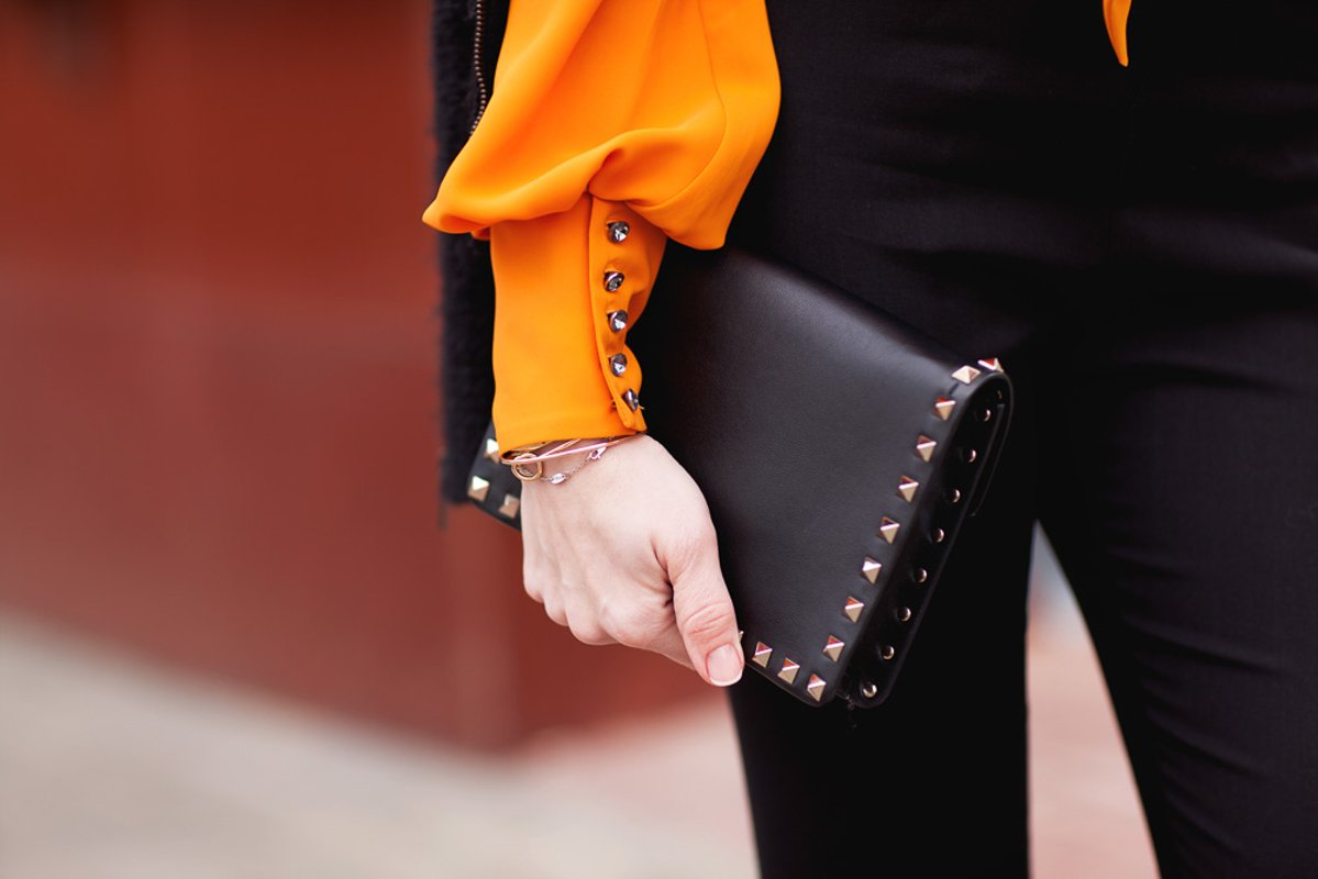 Clothing details, black jacket, black pants, orange blouse example image 1