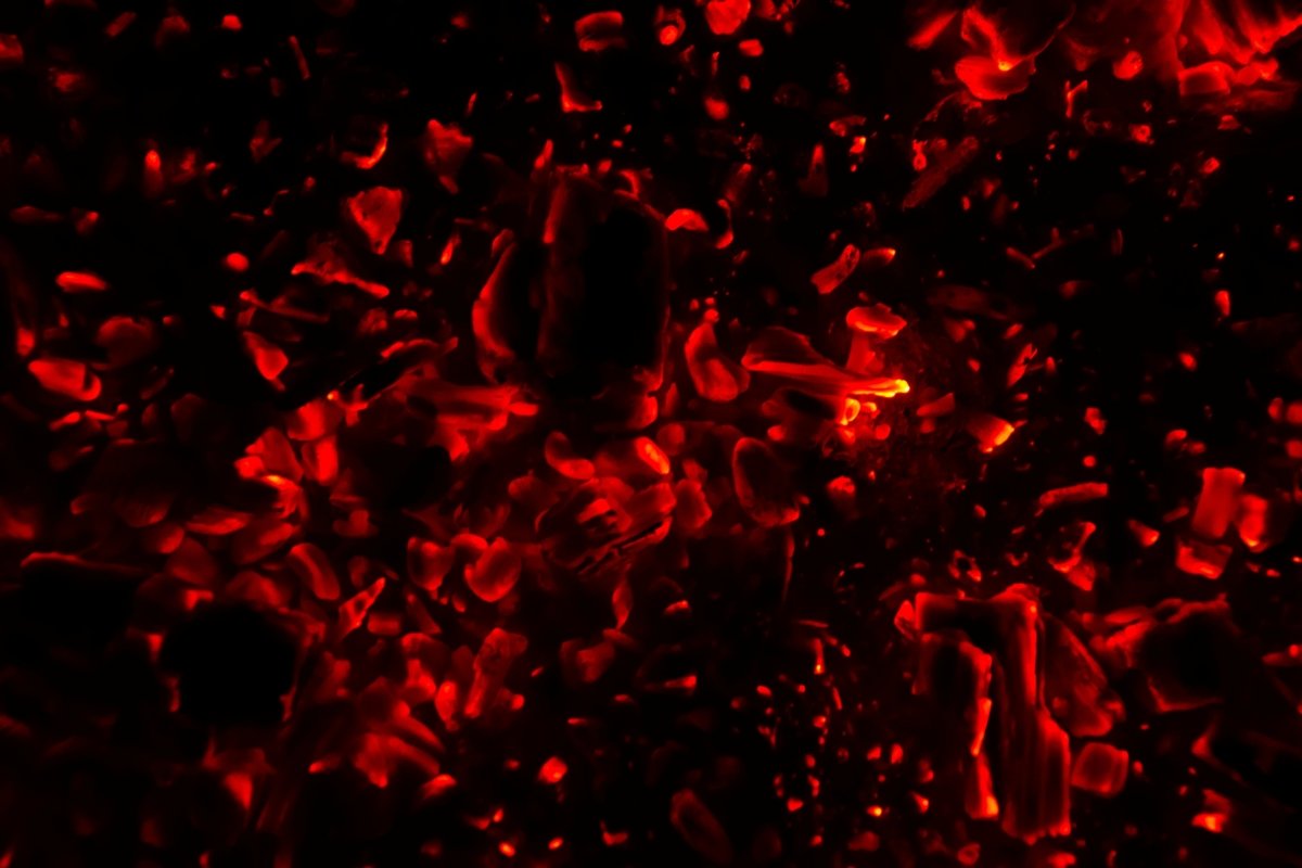 Actively smoldering embers of fire. Burning hot coals example image 1