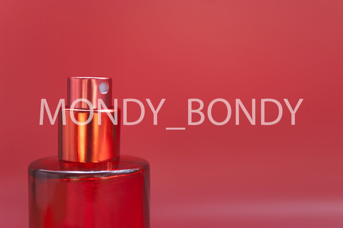 Open bottle of perfume on a pink background example image 1