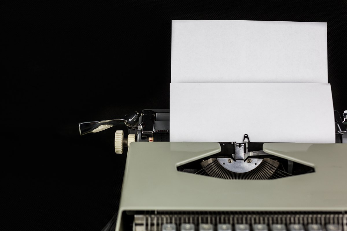 Typewriter on the table on a black background example image 1