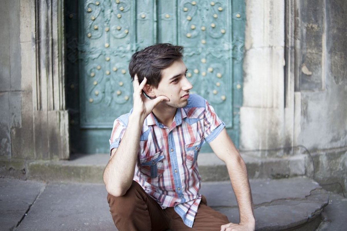 Young man walks in the city example image 1