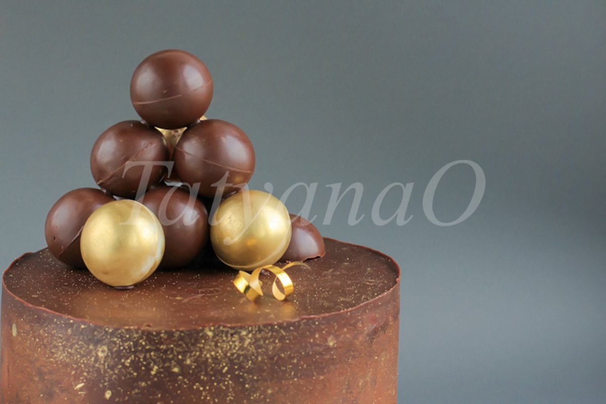 Chocolate birthday cake with gold decorations. example image 1