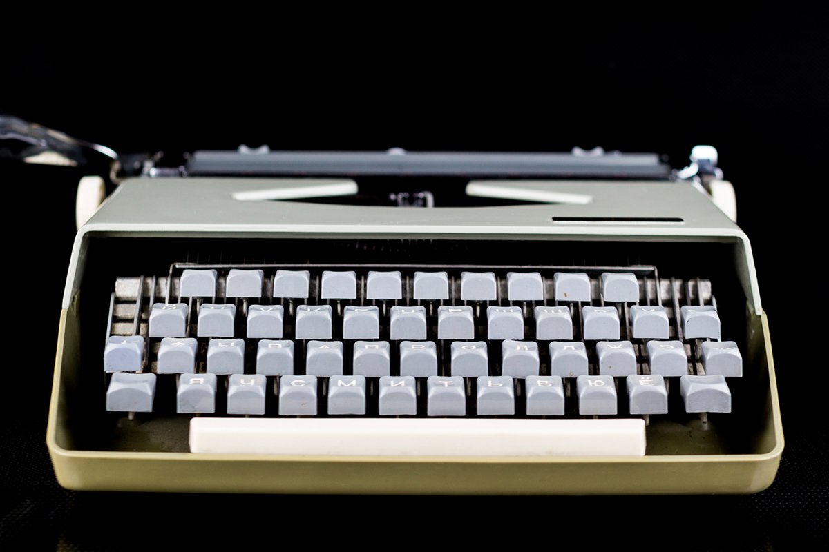 Typewriter on the table on a black background example image 1