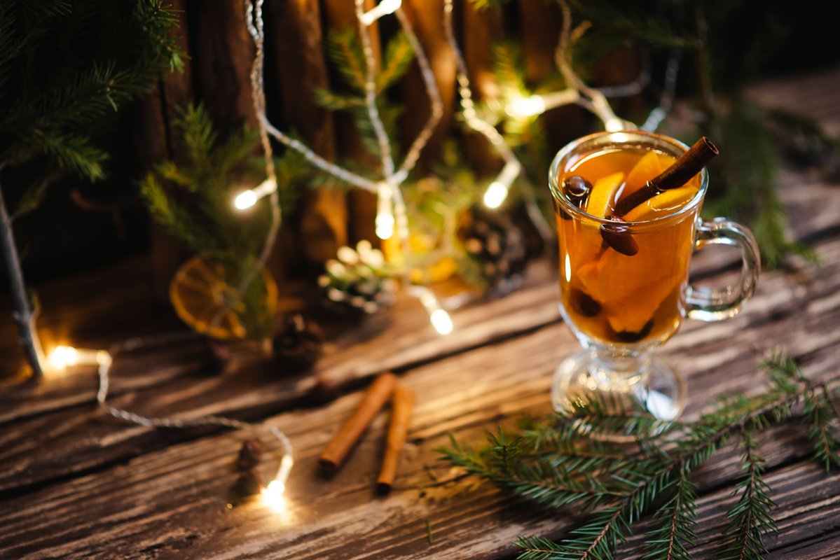 Homemade tea with citrus and cinnamon on a wooden table example image 1