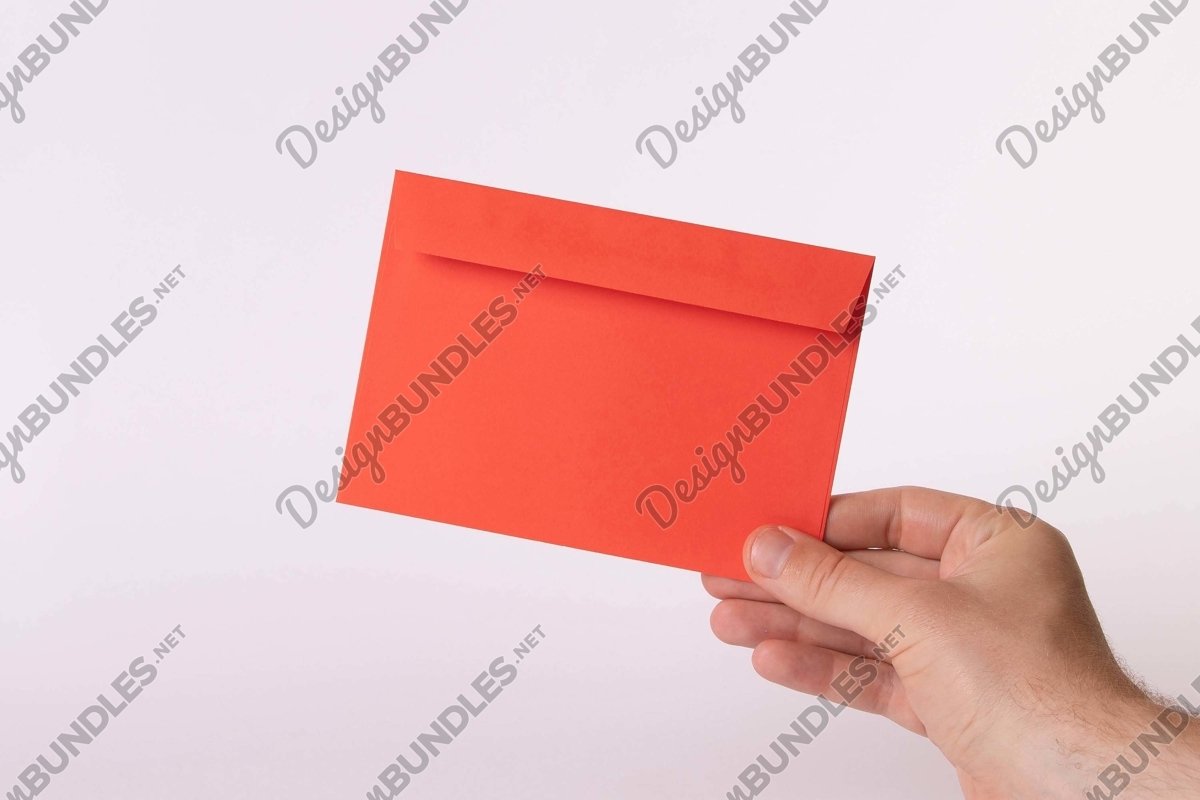 Stock Photo - Close-Up Of Hand Holding Blank Red Paper example image 1