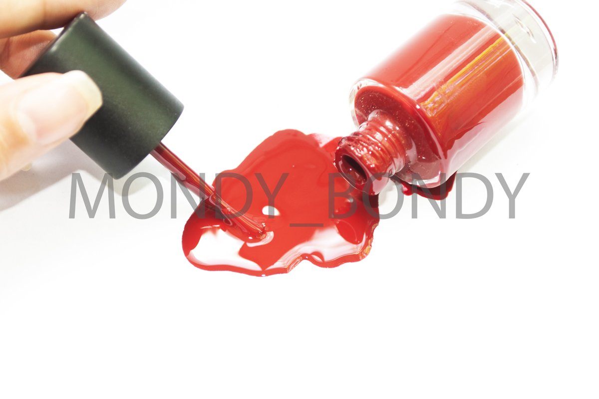 A bottled bottle of red nail polish. Drip varnish example image 1