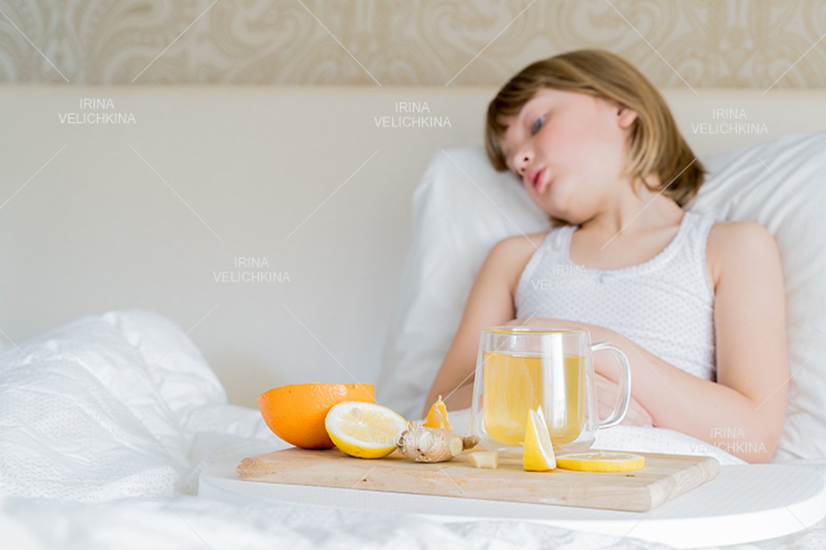 Sick girl in bed. Cup of flu drugs. Tea, orange,lemon,ginger example image 1