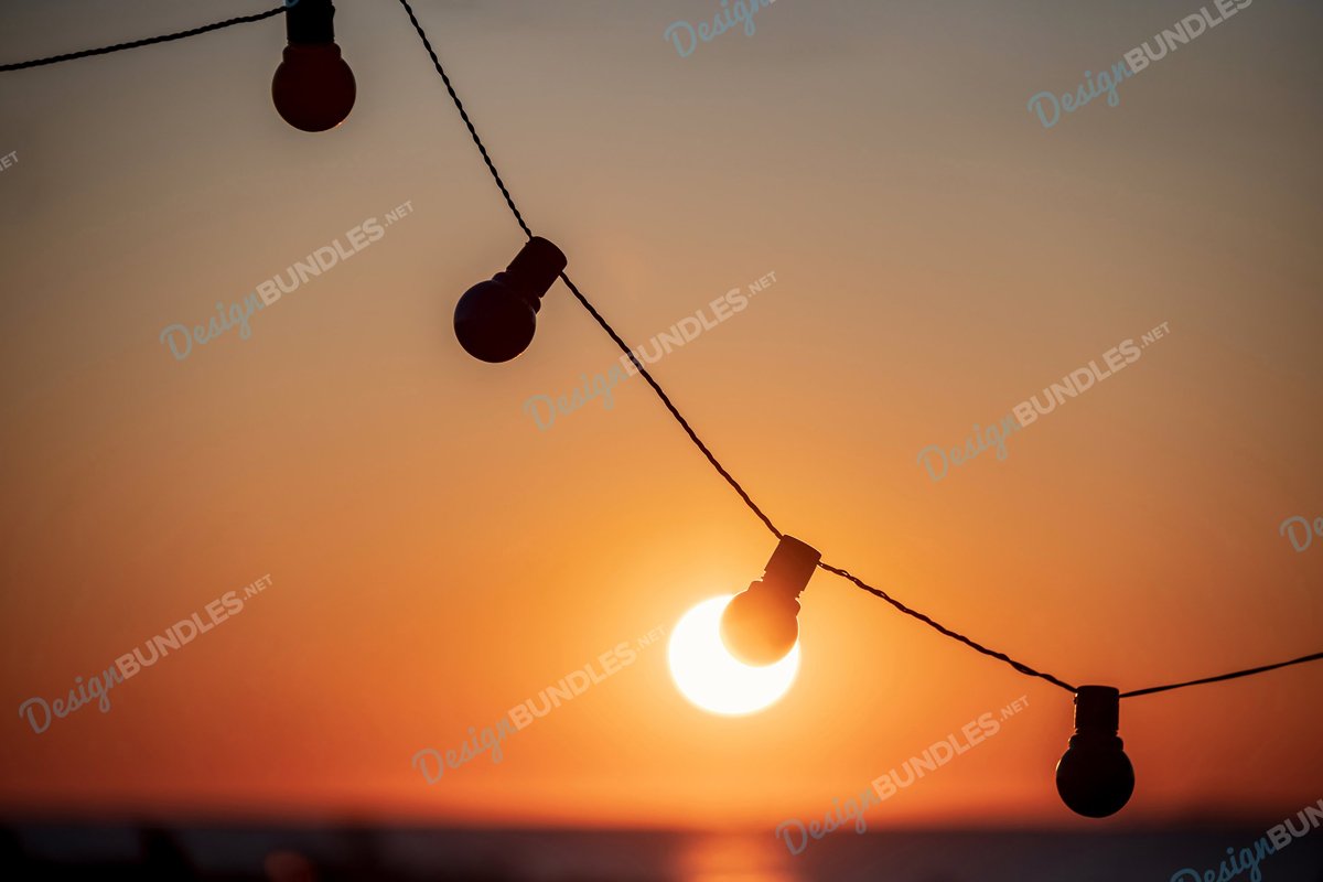 Stock Photo - Silhouette of incandescent lamps at sunset example image 1