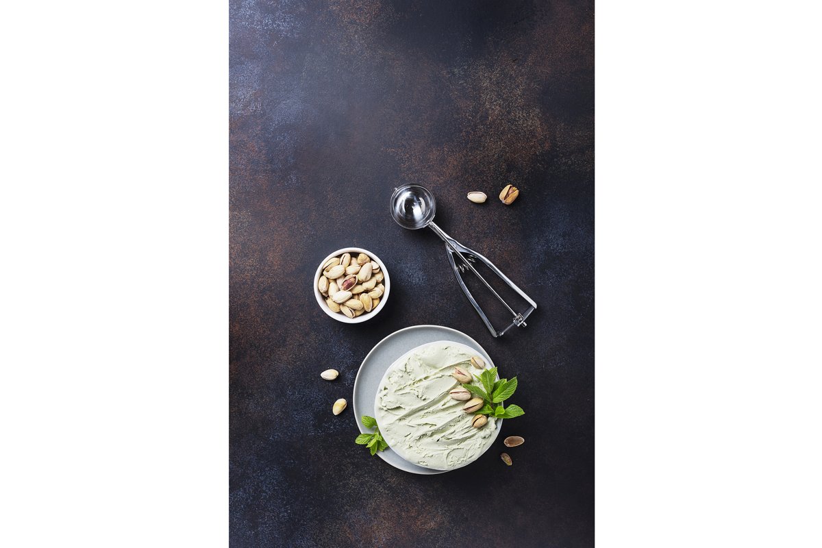 Homemade ice cream with pistachio and mint in ceramic bowl example image 1