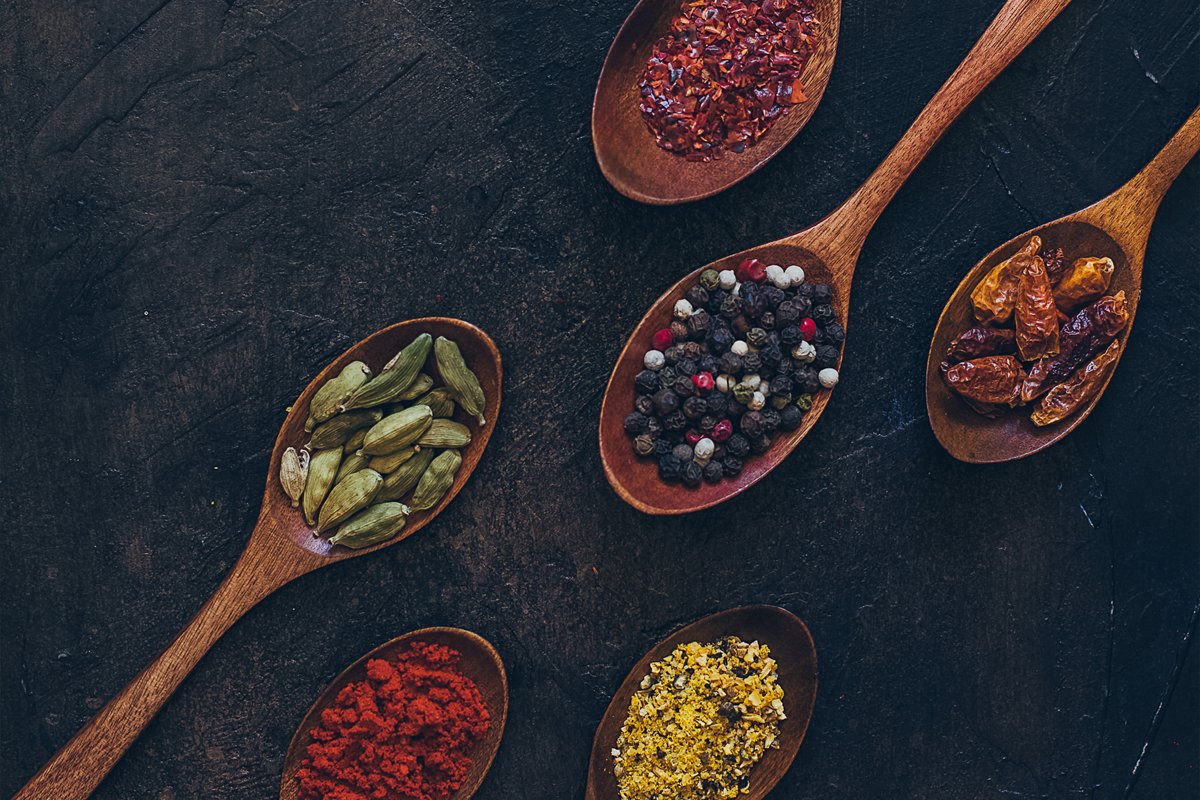Colorful various spices in wooden spoons on old dark example image 1