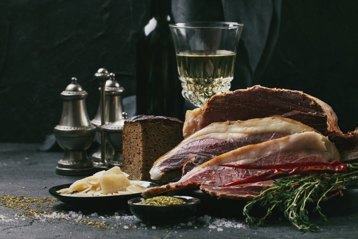 Prosciutto Ham served on a rustic wooden board example image 1