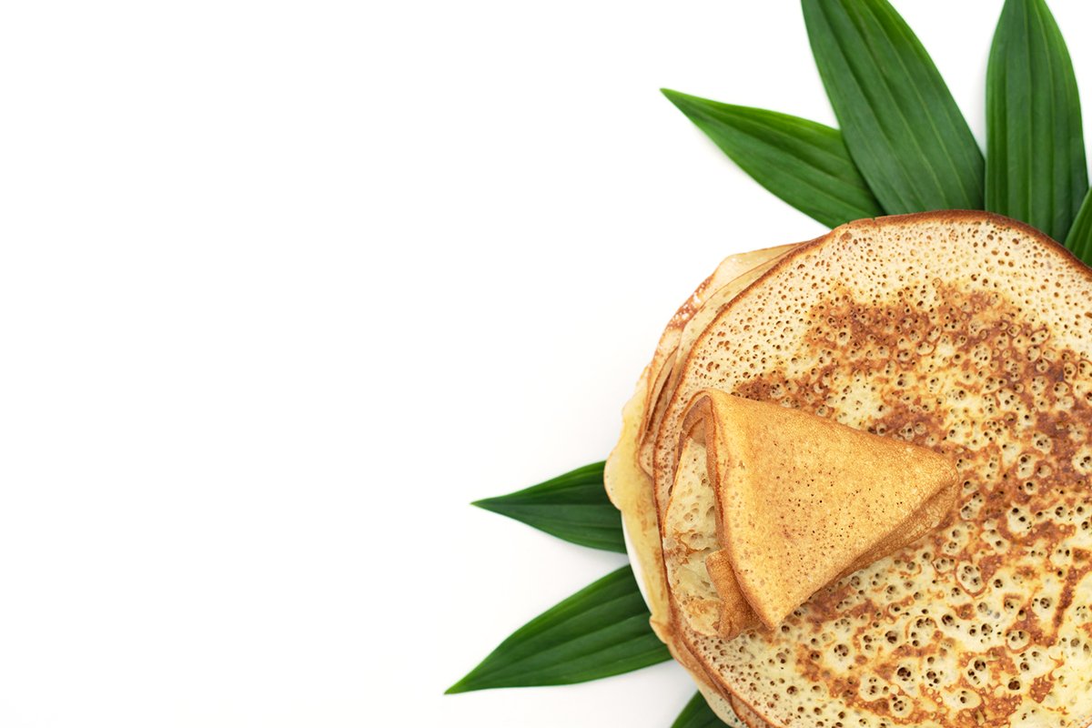 Homemade pancakes on white background with green leaves example image 1