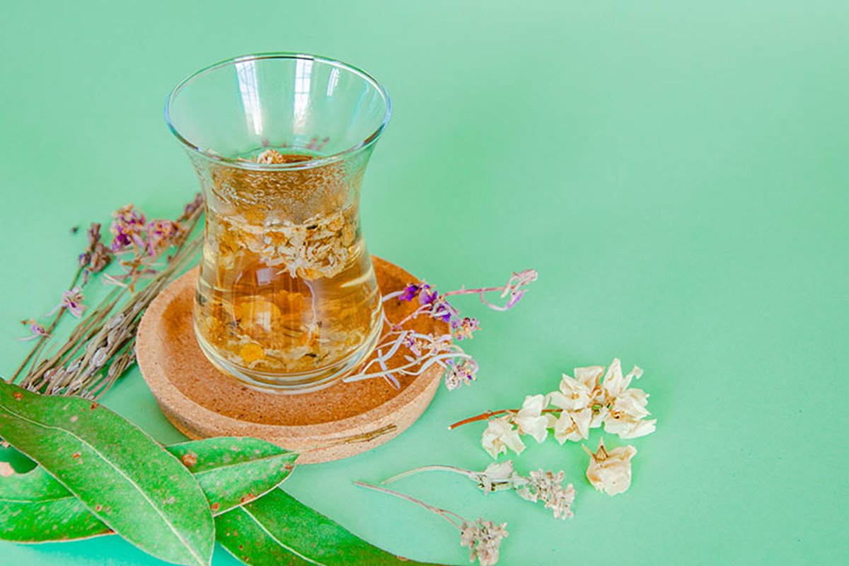 Cup of herbal tea with chamomile flowers. example image 1