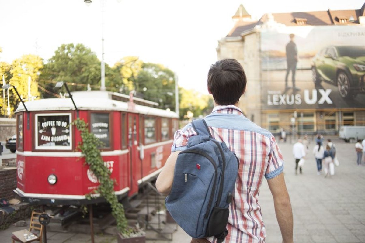 Young man walks in the city example image 1