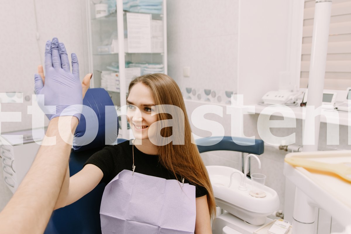 Dental clinic patient, sitting in a chair, claps example image 1