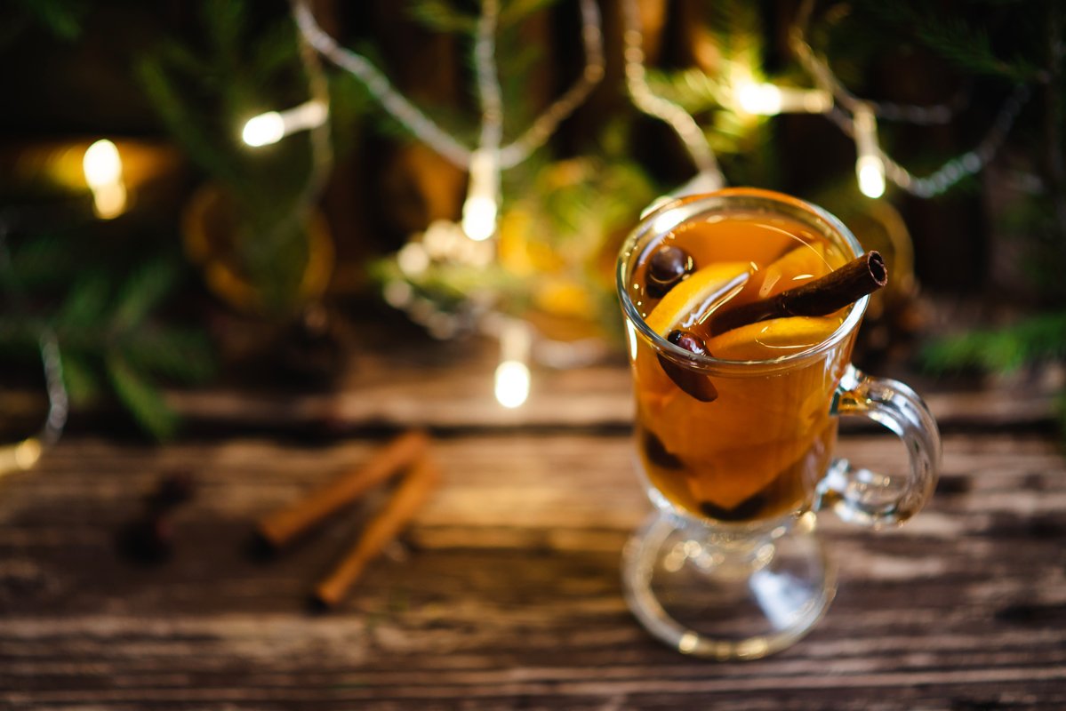 Homemade tea with citrus and cinnamon on a wooden table example image 1