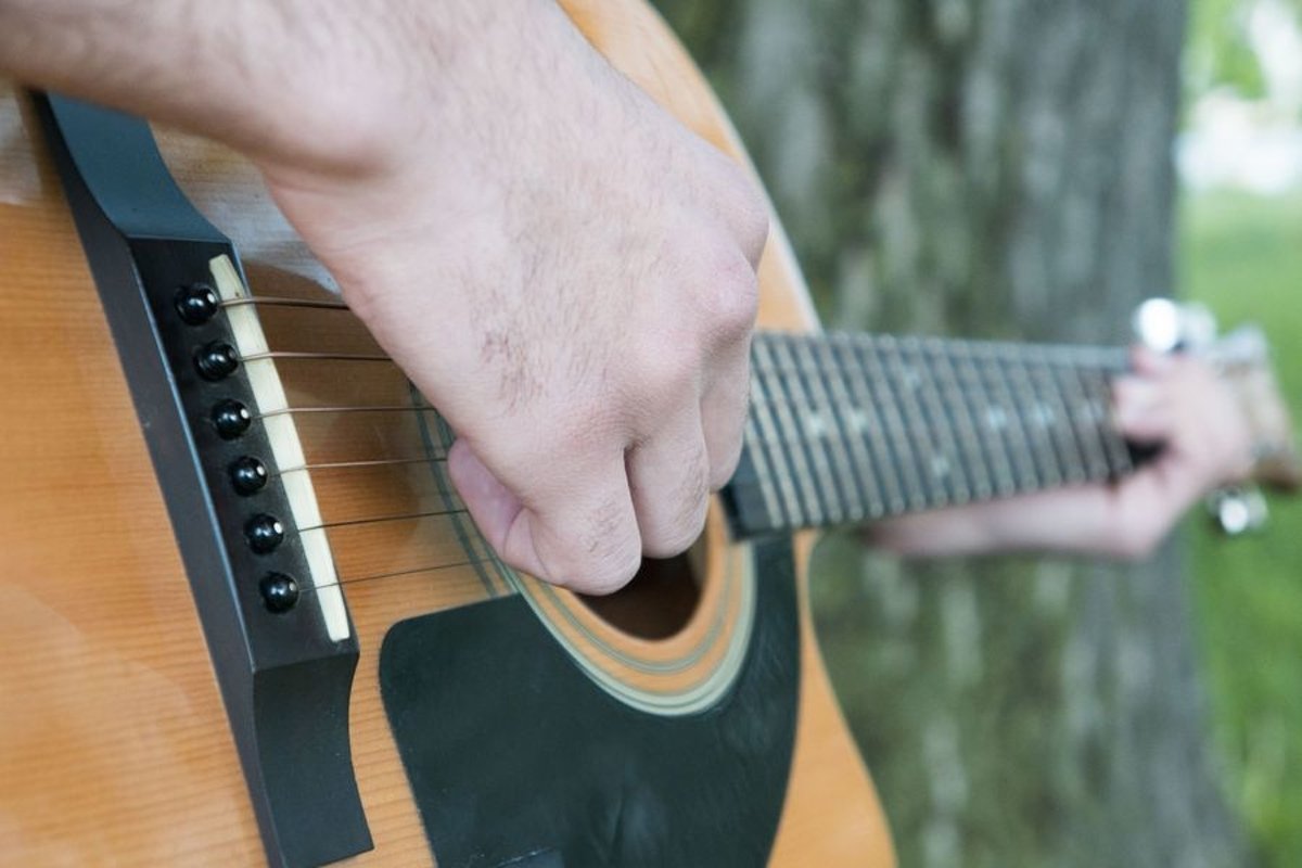 Young caucasian man with guitar in the park example image 1