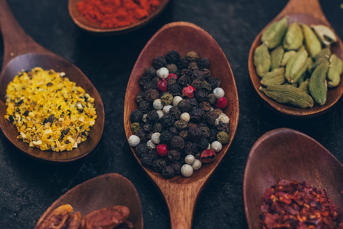Colorful various spices in wooden spoons on old dark example image 1