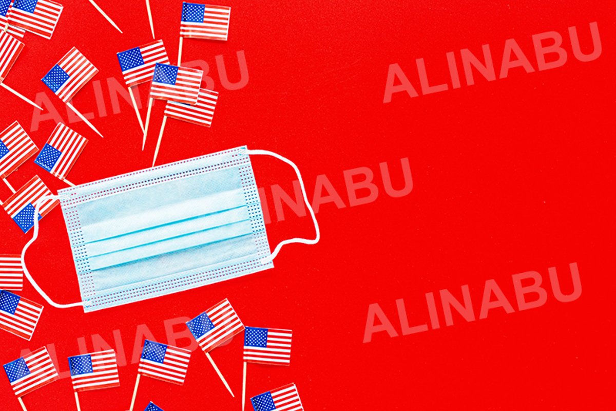 July 4th. USA flags and medical mask on red background example image 1