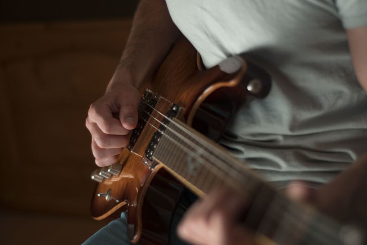 Man plays on electric guitar in studio example image 1