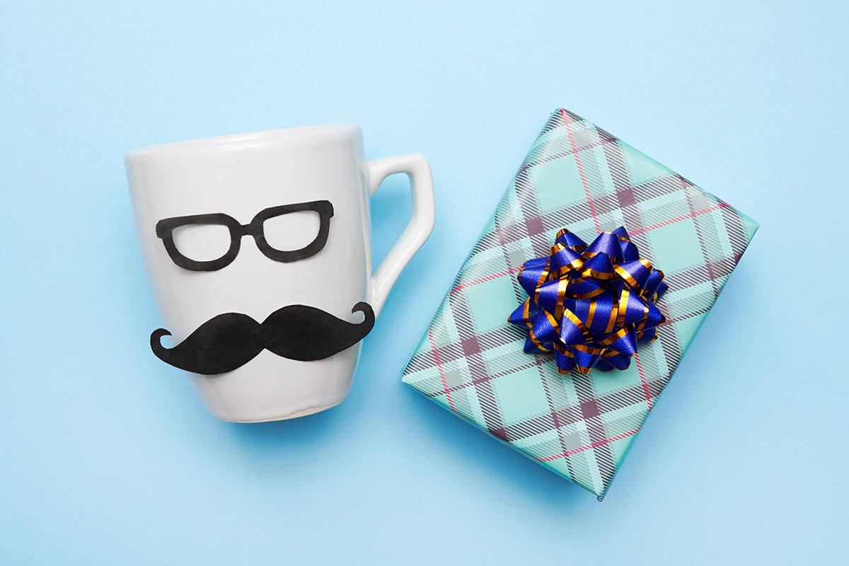 handmade White male cup and gift box on blue background example image 1