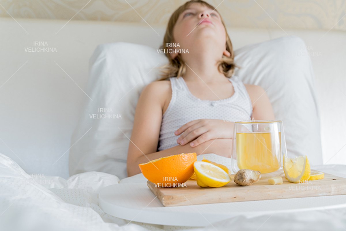 Sick girl in bed. Cup of flu drugs. Tea, orange,lemon,ginger example image 1