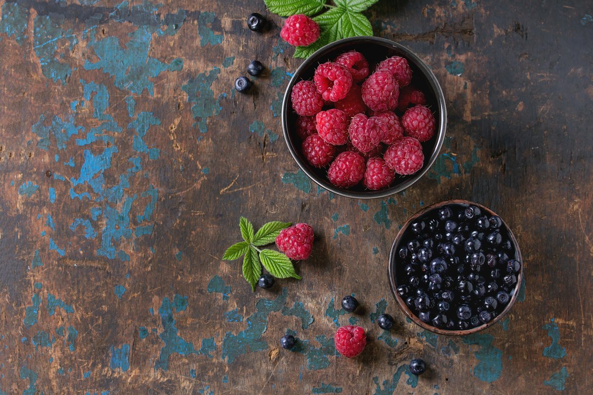 Bowls of raspberries and blueberries example image 1