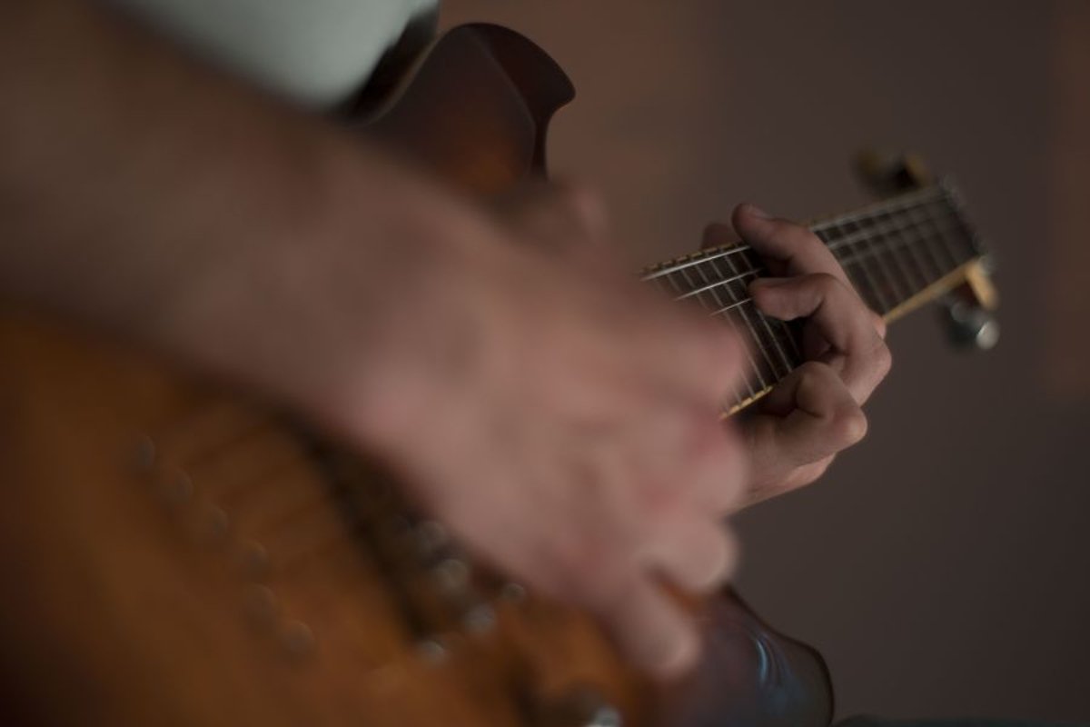 Man plays on electric guitar in studio example image 1